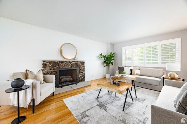 1151 E Chevy Chase Dr, Murray, UT 84117 - living room featuring baseboards, wood finished floors, and a fireplace