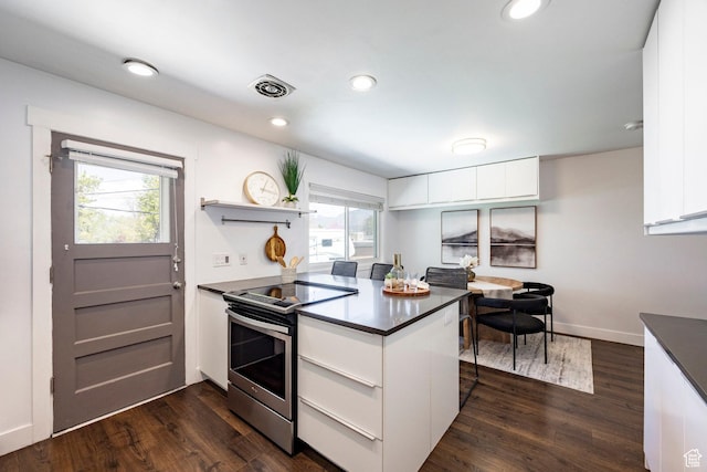 1151 E Chevy Chase Dr, Murray, UT 84117 - kitchen with dark wood-type flooring, a peninsula, white cabinetry, dark countertops, and electric range