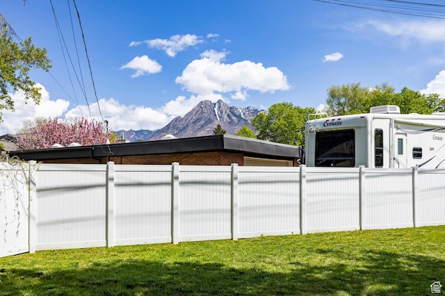 1151 E Chevy Chase Dr, Murray, UT 84117 - exterior space featuring fence, a lawn, and a mountain view