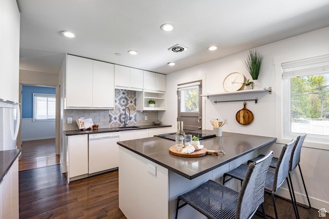 1151 E Chevy Chase Dr, Murray, UT 84117 - kitchen with open shelves, white dishwasher, dark countertops, a sink, and stovetop