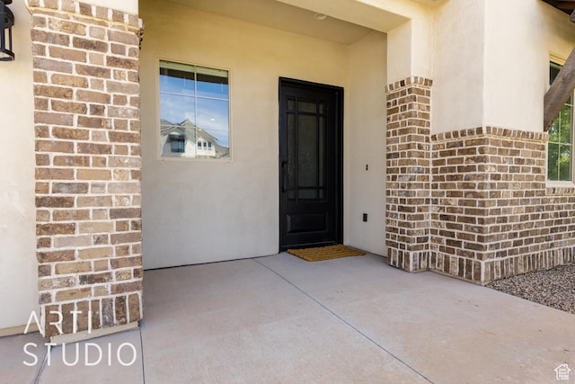 309 W Blue Quartz Dr, Washington, UT 84780 - view of exterior entry featuring brick siding and stucco siding