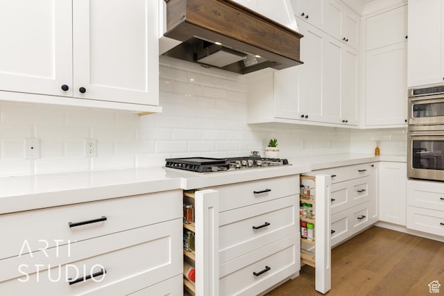 309 W Blue Quartz Dr, Washington, UT 84780 - kitchen featuring white cabinets, appliances with stainless steel finishes, light countertops, extractor fan, and backsplash