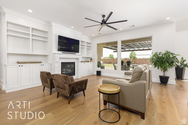 309 W Blue Quartz Dr, Washington, UT 84780 - living area with recessed lighting, light wood-style floors, ceiling fan, a glass covered fireplace, and baseboards