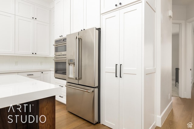 309 W Blue Quartz Dr, Washington, UT 84780 - kitchen with light wood finished floors, white cabinets, appliances with stainless steel finishes, and light countertops