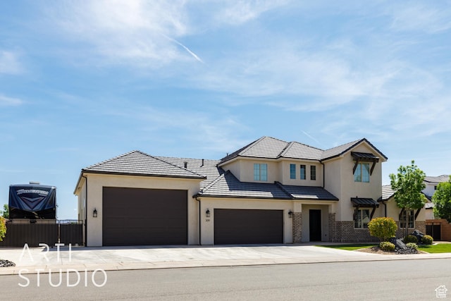 309 W Blue Quartz Dr, Washington, UT 84780 - view of front facade featuring stucco siding, fence, concrete driveway, and an attached garage