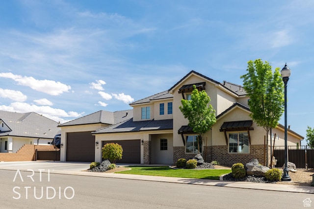 309 W Blue Quartz Dr, Washington, UT 84780 - view of front of property featuring a garage, brick siding, concrete driveway, stucco siding, and fence