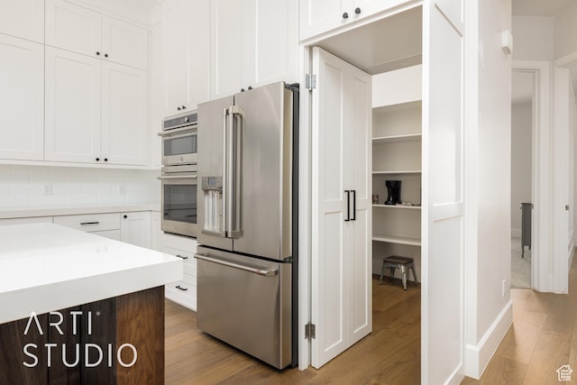 309 W Blue Quartz Dr, Washington, UT 84780 - kitchen featuring appliances with stainless steel finishes, wood finished floors, and white cabinets