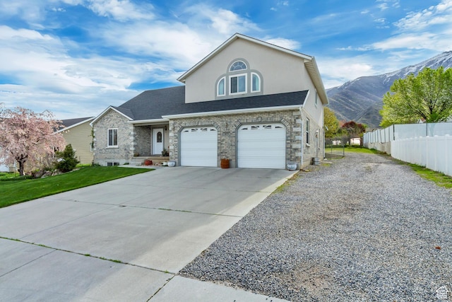 577 S 500 E, Santaquin, UT 84655 - view of front of house with driveway, stucco siding, a mountain view, fence, and a garage