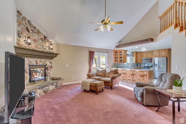 577 S 500 E, Santaquin, UT 84655 - living room featuring light colored carpet, ceiling fan, baseboards, high vaulted ceiling, and a stone fireplace