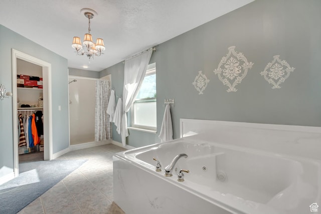 577 S 500 E, Santaquin, UT 84655 - bathroom with a chandelier, a stall shower, a tub with jets, a spacious closet, and tile patterned flooring