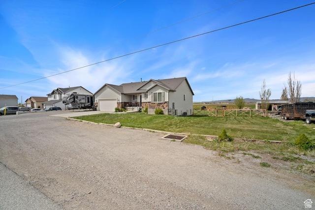 9457 N 4800 W, Elwood, UT 84337 - single story home with a front lawn, a garage, a residential view, driveway, and fence