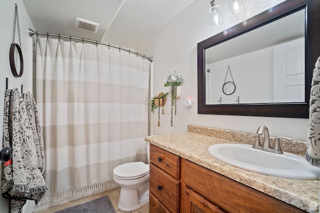 9457 N 4800 W, Elwood, UT 84337 - bathroom featuring visible vents, tile patterned flooring, toilet, vanity, and curtained shower