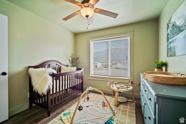 9457 N 4800 W, Elwood, UT 84337 - bedroom featuring a crib, a ceiling fan, wood finished floors, and baseboards