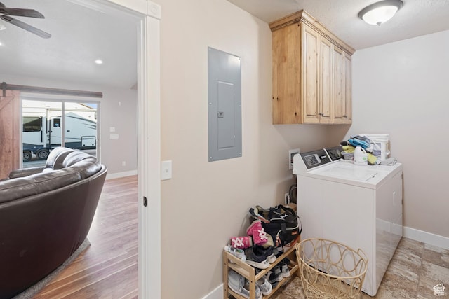laundry room featuring washer and dryer, cabinet space, ceiling fan, electric panel, and baseboards