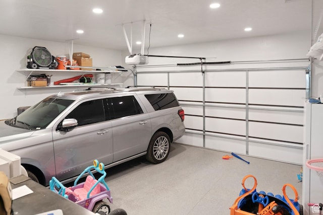 garage with recessed lighting and a garage door opener