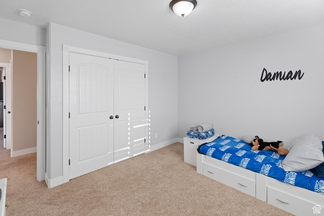 unfurnished bedroom featuring baseboards, a closet, and carpet