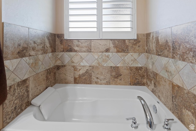 full bathroom with a tub and a wealth of natural light
