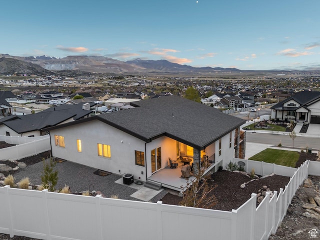 6593 W Bonnie Jean Ln Unit 13, Herriman, UT 84096 - back of property with a mountain view, a patio, stucco siding, and a fenced backyard