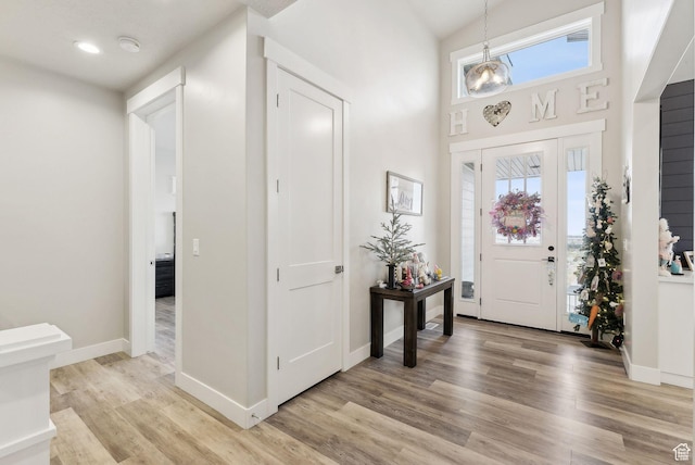6593 W Bonnie Jean Ln Unit 13, Herriman, UT 84096 - entrance foyer with baseboards, light wood finished floors, and a towering ceiling
