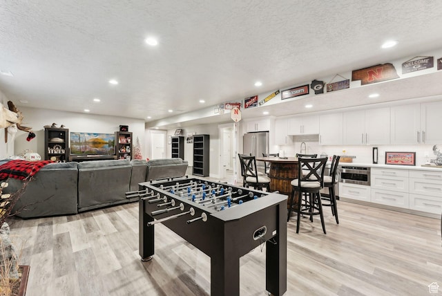 6593 W Bonnie Jean Ln Unit 13, Herriman, UT 84096 - rec room featuring light wood finished floors, a textured ceiling, and recessed lighting