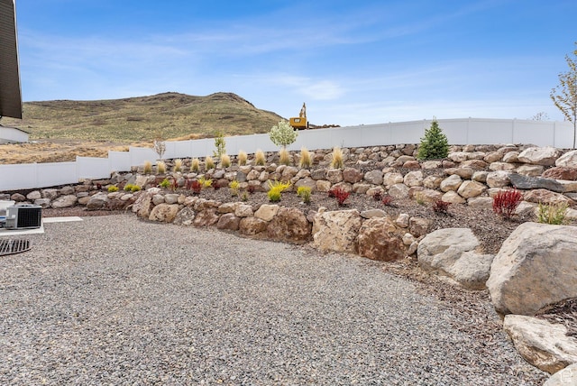 6593 W Bonnie Jean Ln Unit 13, Herriman, UT 84096 - view of yard featuring fence, central AC unit, and a mountain view