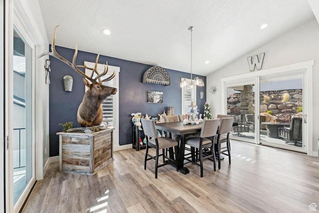 6593 W Bonnie Jean Ln Unit 13, Herriman, UT 84096 - dining space featuring wood finished floors, plenty of natural light, a notable chandelier, and vaulted ceiling