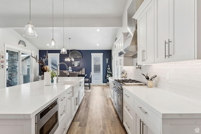 6593 W Bonnie Jean Ln Unit 13, Herriman, UT 84096 - kitchen featuring recessed lighting, a sink, wall chimney exhaust hood, white cabinets, and appliances with stainless steel finishes