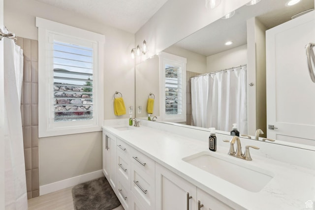6593 W Bonnie Jean Ln Unit 13, Herriman, UT 84096 - bathroom with a healthy amount of sunlight, baseboards, and a sink