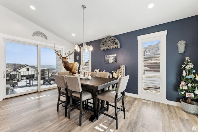 6593 W Bonnie Jean Ln Unit 13, Herriman, UT 84096 - dining space with an inviting chandelier, a wealth of natural light, and light wood-style flooring