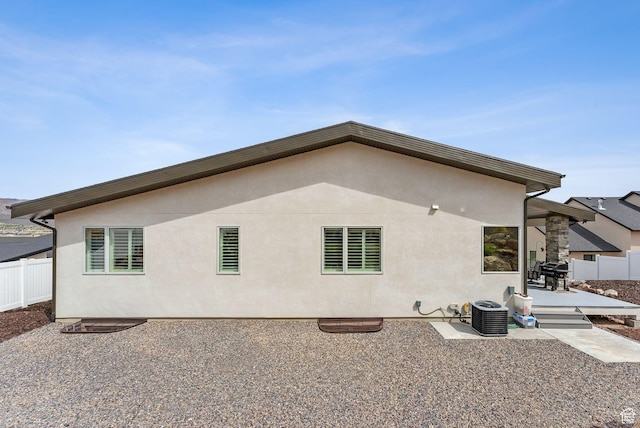 6593 W Bonnie Jean Ln Unit 13, Herriman, UT 84096 - rear view of property featuring a patio, central air condition unit, stucco siding, and fence