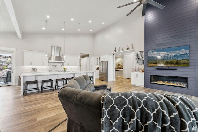6593 W Bonnie Jean Ln Unit 13, Herriman, UT 84096 - living area with light wood-type flooring, recessed lighting, ceiling fan, and a towering ceiling