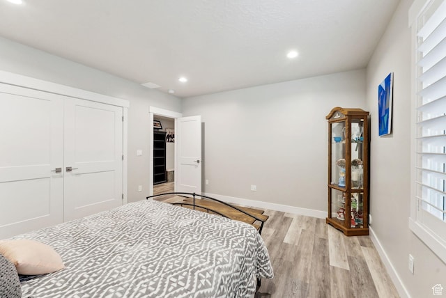 6593 W Bonnie Jean Ln Unit 13, Herriman, UT 84096 - bedroom featuring a closet, recessed lighting, light wood-style flooring, and baseboards
