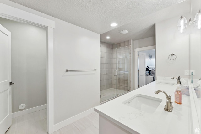 6593 W Bonnie Jean Ln Unit 13, Herriman, UT 84096 - bathroom with a textured ceiling, a shower stall, recessed lighting, and a sink