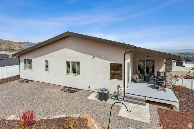 6593 W Bonnie Jean Ln Unit 13, Herriman, UT 84096 - rear view of property featuring stucco siding, fence, cooling unit, and a patio area