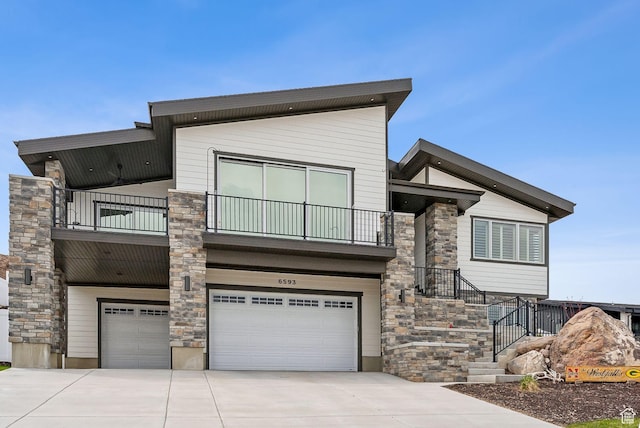 6593 W Bonnie Jean Ln Unit 13, Herriman, UT 84096 - contemporary home with concrete driveway, stone siding, an attached garage, and a balcony