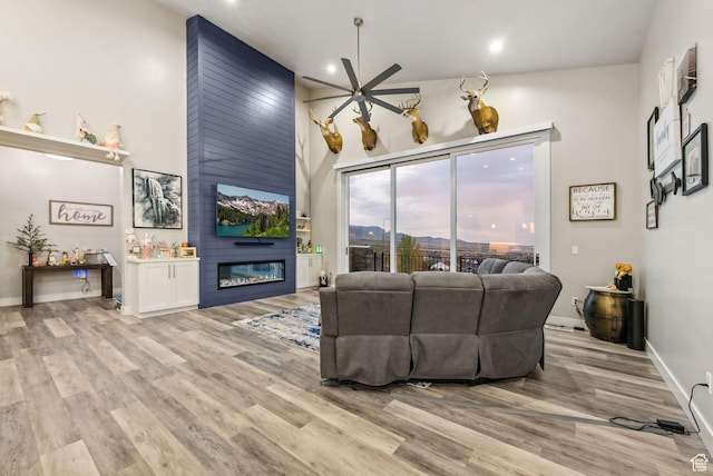 6593 W Bonnie Jean Ln Unit 13, Herriman, UT 84096 - living room with light wood-style flooring, baseboards, recessed lighting, a fireplace, and a ceiling fan
