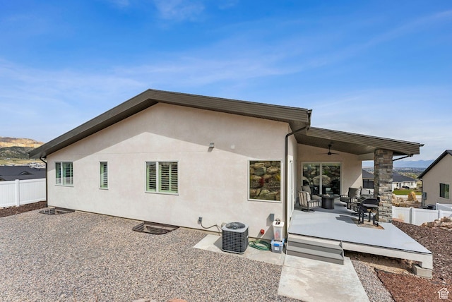 6593 W Bonnie Jean Ln Unit 13, Herriman, UT 84096 - rear view of house with fence, a ceiling fan, a patio area, and central AC