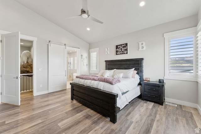 6593 W Bonnie Jean Ln Unit 13, Herriman, UT 84096 - bedroom featuring a barn door, visible vents, light wood-style flooring, vaulted ceiling, and baseboards