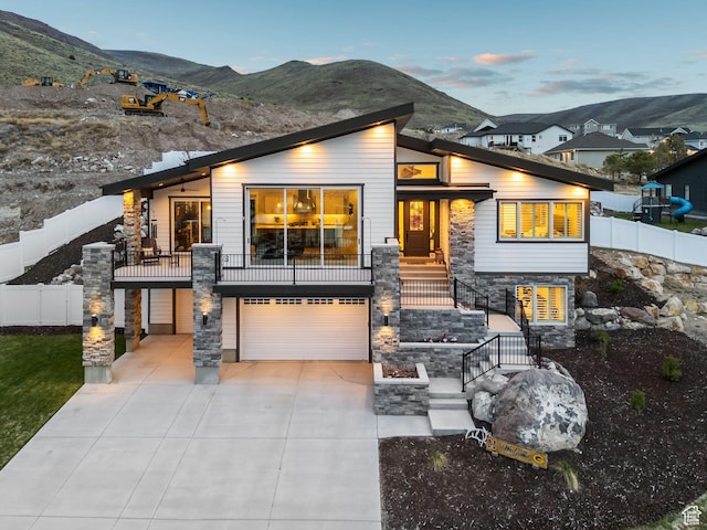 6593 W Bonnie Jean Ln Unit 13, Herriman, UT 84096 - contemporary home featuring stairs, a mountain view, an attached garage, and stone siding