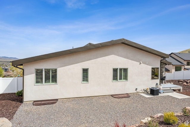 6593 W Bonnie Jean Ln Unit 13, Herriman, UT 84096 - back of property with fence, central AC unit, a patio area, and stucco siding
