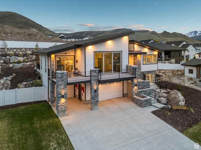 6593 W Bonnie Jean Ln Unit 13, Herriman, UT 84096 - back of house with a yard, fence, driveway, a mountain view, and an attached garage