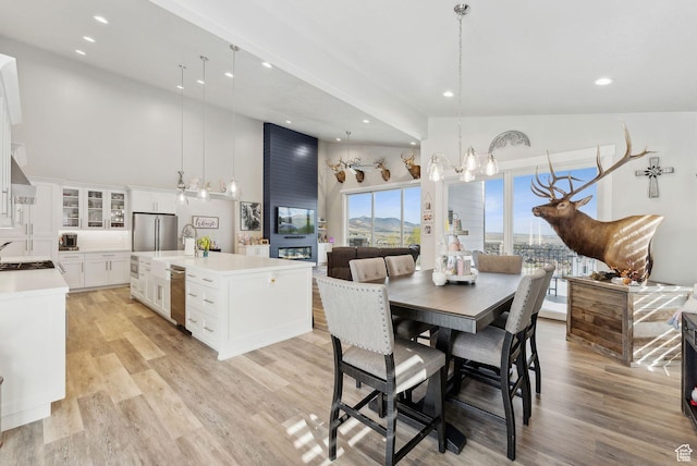 6593 W Bonnie Jean Ln Unit 13, Herriman, UT 84096 - dining area with recessed lighting, an inviting chandelier, high vaulted ceiling, and light wood-type flooring