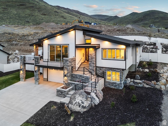 6593 W Bonnie Jean Ln Unit 13, Herriman, UT 84096 - contemporary home with a garage, a mountain view, driveway, stone siding, and fence