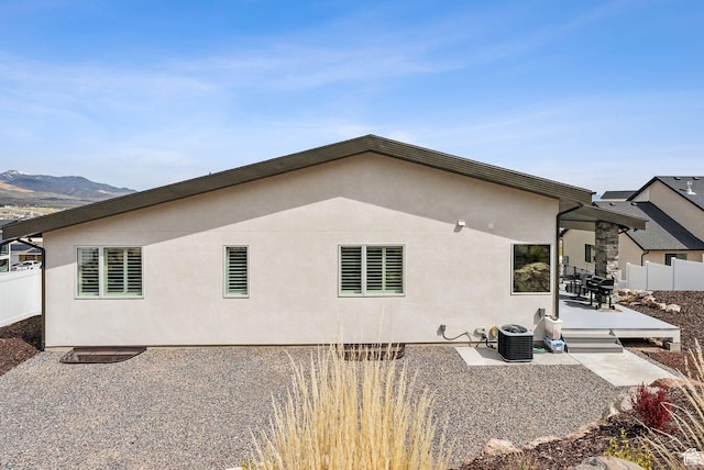 6593 W Bonnie Jean Ln Unit 13, Herriman, UT 84096 - rear view of property with fence, cooling unit, a patio area, and stucco siding