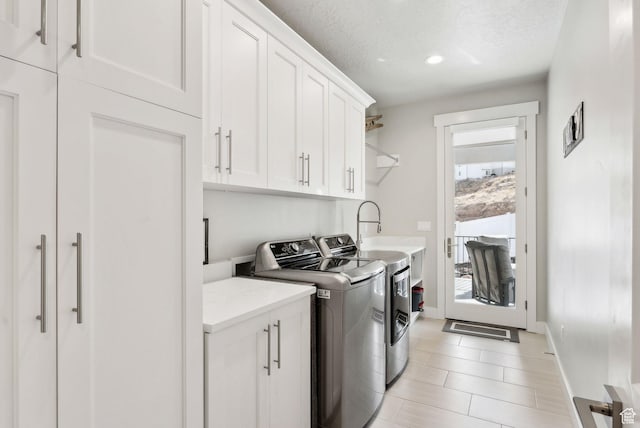 6593 W Bonnie Jean Ln Unit 13, Herriman, UT 84096 - washroom featuring recessed lighting, cabinet space, a sink, baseboards, and washing machine and dryer