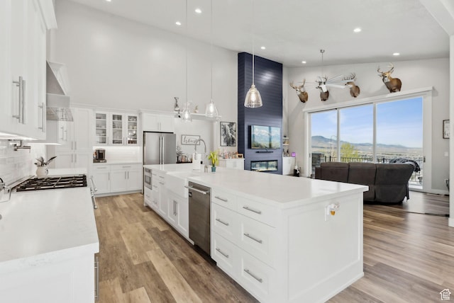6593 W Bonnie Jean Ln Unit 13, Herriman, UT 84096 - kitchen with recessed lighting, stainless steel appliances, wall chimney exhaust hood, light countertops, and a towering ceiling
