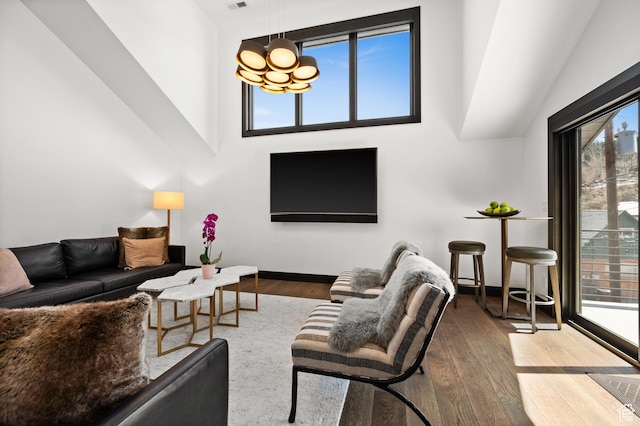 88 King Rd, Park City, UT 84060 - living room with baseboards, a high ceiling, wood finished floors, and a chandelier