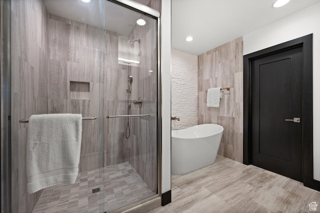 88 King Rd, Park City, UT 84060 - bathroom with a freestanding bath, tile walls, a stall shower, and recessed lighting