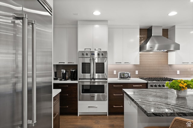 88 King Rd, Park City, UT 84060 - kitchen featuring wall chimney range hood, modern cabinets, stainless steel appliances, and dark brown cabinets
