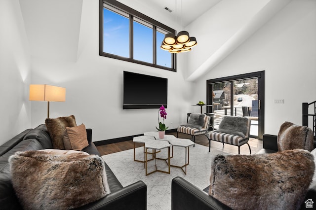 88 King Rd, Park City, UT 84060 - living area with baseboards, visible vents, wood finished floors, and a towering ceiling